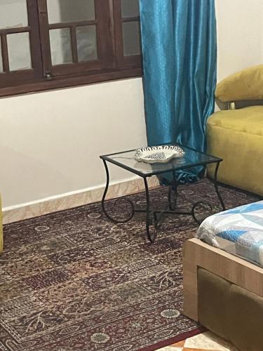 a living room with a glass table and a couch at Vu sur corniche in Safi