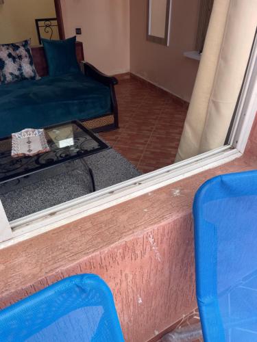 a mirror in a room with a bed and a couch at Vu sur corniche in Safi