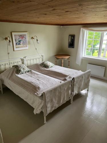 a bedroom with a large bed and a window at Romantic Villa in historic setting with lake view in Säffle