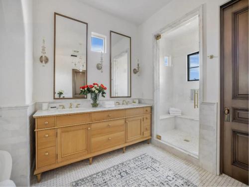 a bathroom with a double sink and a tub at Casa Tranquila Malibu in Malibu