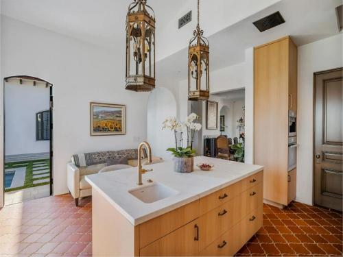 a kitchen with a sink and a living room at Casa Tranquila Malibu in Malibu