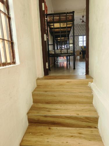 a hallway with wooden stairs in an old building at ROYAL Homestay in Salem
