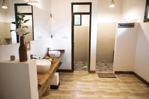 a bathroom with two sinks and a walk in shower at Z-Love Zanzibar in Kiwengwa