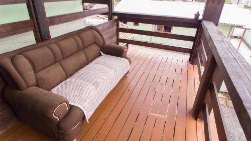 a couch sitting on top of a wooden deck at Pousada bonomo in Urubici
