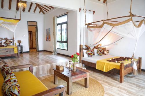 a large room with a bed and a couch at Z-Love Zanzibar in Kiwengwa