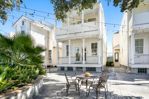 a patio with a table and chairs in front of a building at Fabulous Cottages with City Views in New Orleans