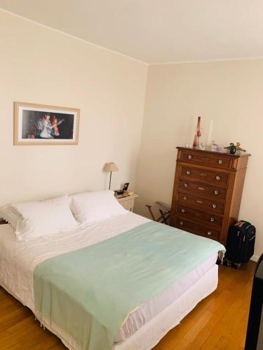 une chambre avec un grand lit et une commode dans l'établissement Lux Apartment Marais Temple, à Paris