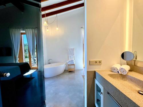 a bathroom with a tub and a sink and a bath room at Finca Sestelrica in Artá