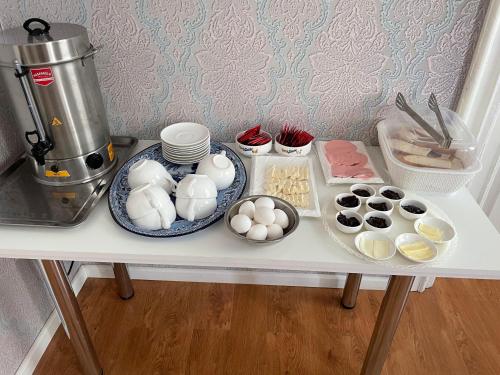 a table with eggs and other ingredients on it at Vintage Boutique Hostel in Baku