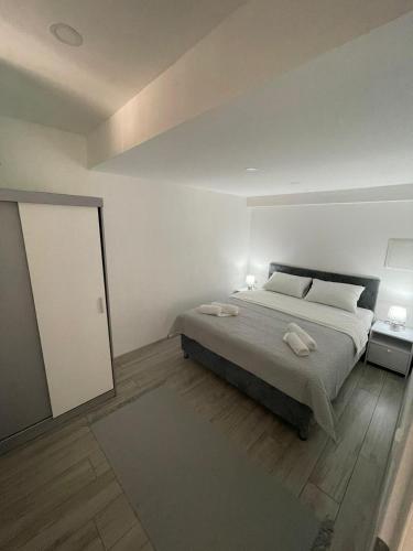 a bedroom with a bed with two towels on it at Apartman Mole in Livno