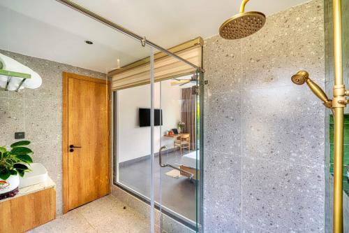 a glass shower with a glass door in a bathroom at Ancasa villa Hội An in An Bang
