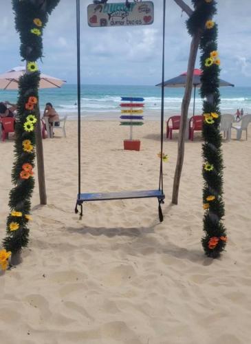 a swing in the sand on a beach at Pousada Bedoya in Nísia Floresta