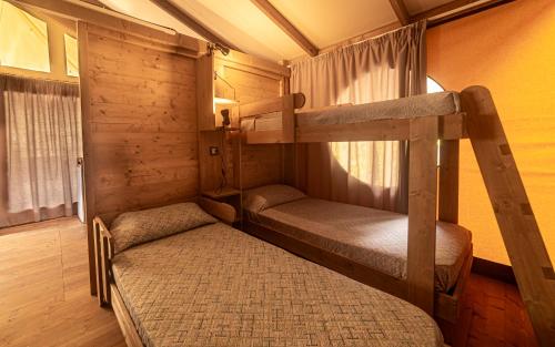 a bedroom with two bunk beds in a cabin at Delle Rose Camping & Glamping Village in Isolabona
