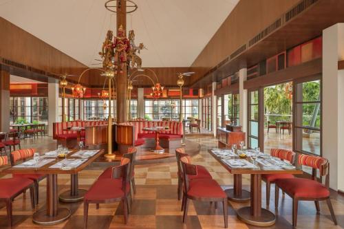 a restaurant with tables and chairs and a chandelier at The St. Regis Bali Resort in Nusa Dua