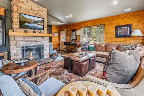 a living room with a couch and a fireplace at Tranquil 4BR on Peak 7 with Hot Tub Dog Friendly in Breckenridge