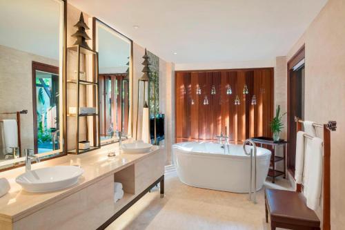 a bathroom with two sinks and a bath tub at The St. Regis Bali Resort in Nusa Dua