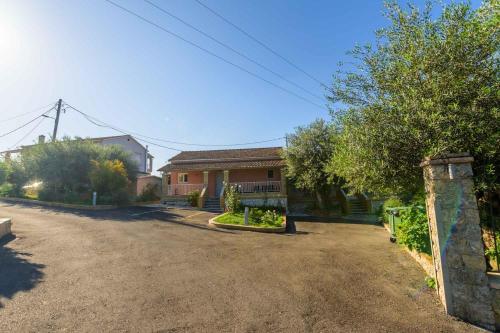 a house with a driveway in front of it at Spyridoula Resort in Corfu in Gouvia