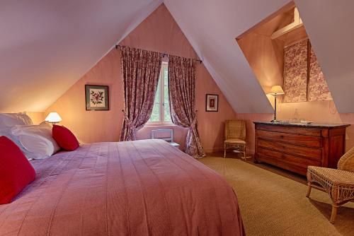 a bedroom with a large bed and a window at Château De La Bourdaisière in Montlouis-sur-Loire