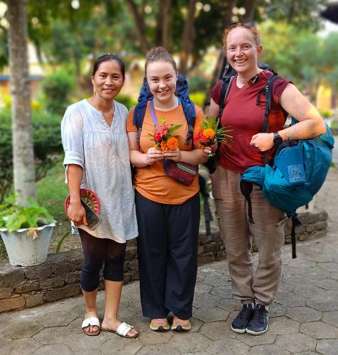 three women standing next to each other holding flowers at Mr. B's Place in Bhurkīā