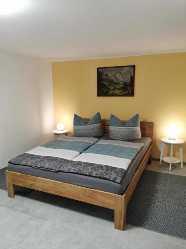 a bedroom with a large bed with two tables at Ferienhaus Wanderlust in Waltershausen