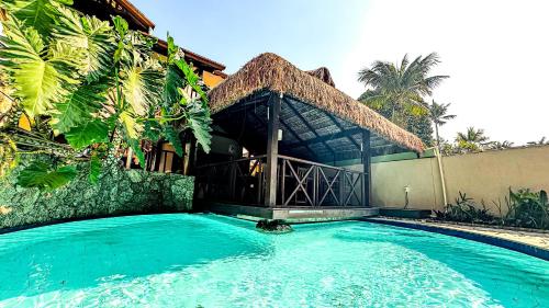 a large swimming pool in front of a building at Pousada Villa Aman in Paraty