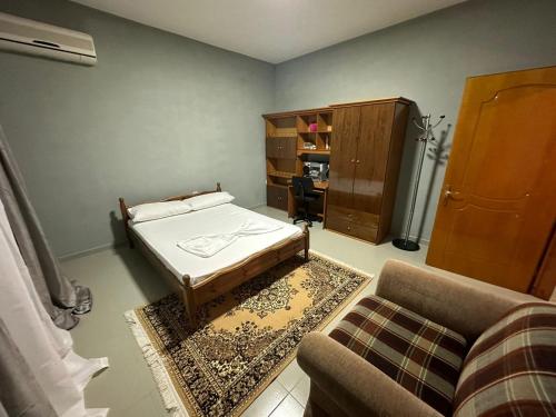a living room with a bed and a couch at Liam rooms in Tepelena Center in Tepelenë