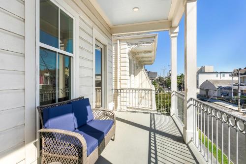 a balcony with a blue chair on a house at Private 3BR on Carondelet by Hosteeva in New Orleans