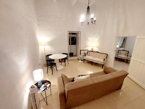 a living room with a couch and a table at townhouse cospicua , ( 3 cities-valletta ) ferry in Cospicua