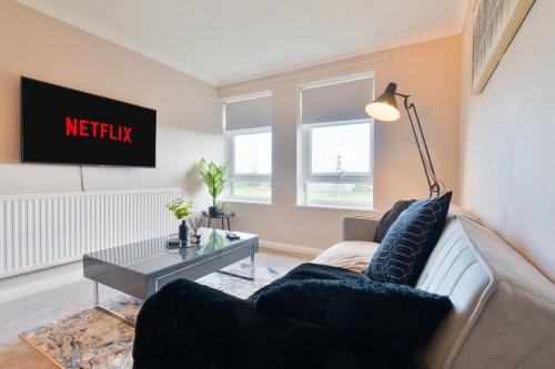 a living room with a couch and a table at Trendy Central Apartment with Free Parking - Perfect for Contractors and Families in Canterbury