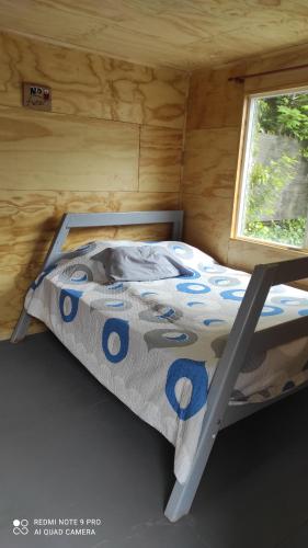 a bed in a small room with a window at hostel centro in Puerto Montt