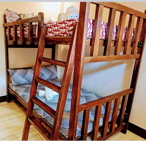 a couple of bunk beds in a room at The Touch Affordable Baguio Apt in Baguio