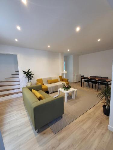 a living room with a couch and a table at Maison COSY 15 mn PARIS - Linges Hotel Confort in Vitry-sur-Seine