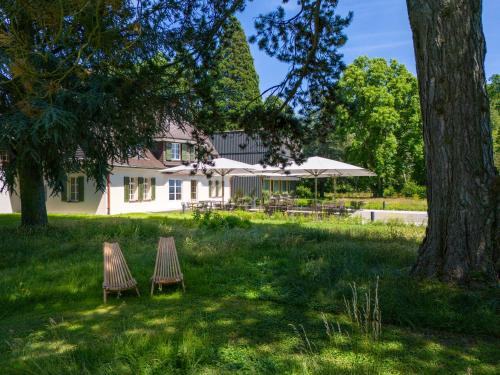 two chairs in the grass in front of a house at Seegut Zeppelin in Friedrichshafen