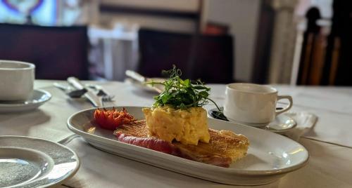 a plate of food on a table with coffee cups at Foley's Townhouse Killarney in Killarney