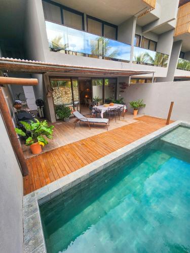 a house with a swimming pool and a patio at Kanui Casa Maré 107 in São Miguel dos Milagres
