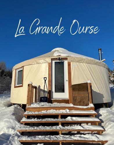 a yurt with a set of stairs in the snow at Yourtes Forillon - à 4km de marche 4km walk in Gaspé