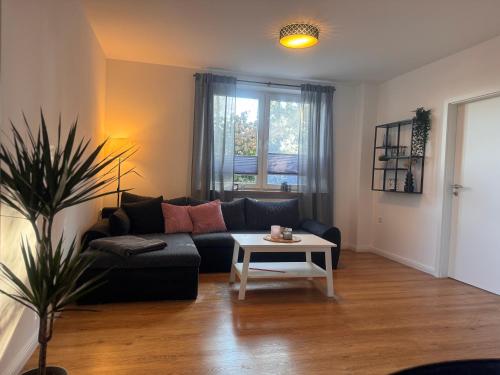 a living room with a couch and a table at Ferienwohnung Holl in Detern