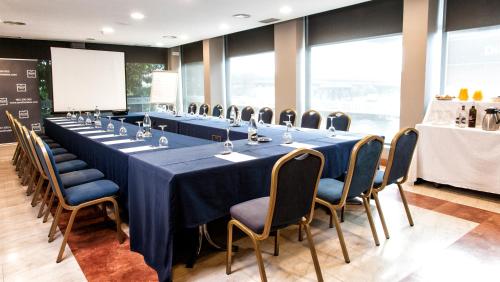 a conference room with a long table and chairs at Zenit Logroño in Logroño