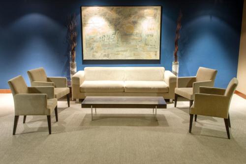 a living room with a white couch and chairs at Zenit Logroño in Logroño
