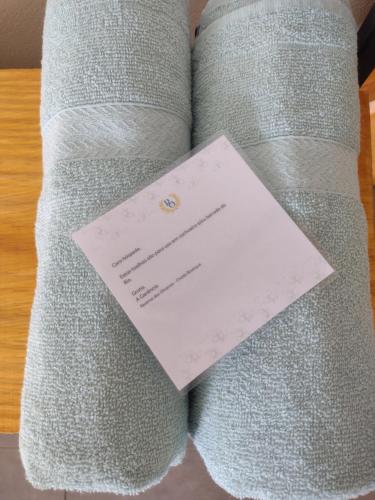 a piece of paper sitting on the arm of a couch at Reserva das Oliveiras in Nova Friburgo