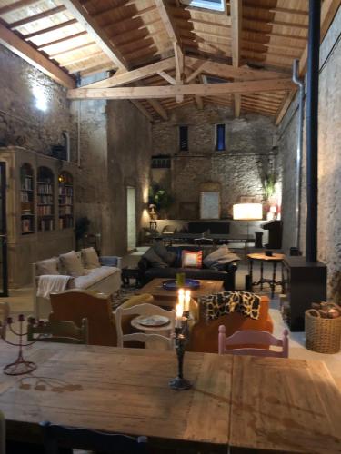 a large living room with a table and chairs at Maison Mia Majorelle in Roujan