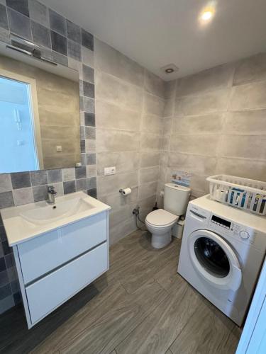 a bathroom with a washing machine and a sink at Penthouse Giner Benidorm centro playa by TRG in Benidorm