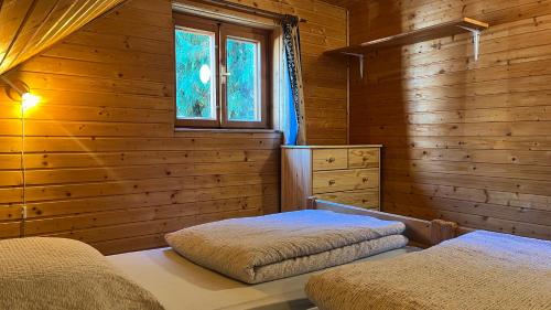 A bed or beds in a room at Chata u Porubäna