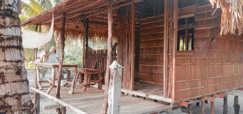 a wooden cabin with a table and chairs on a porch at manyaifun guest house in Minyaifuin