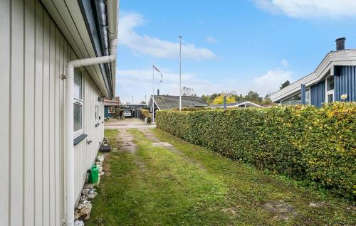 a side of a building next to a hedge at 3 Bedroom Amazing Home In Nyborg in Nyborg