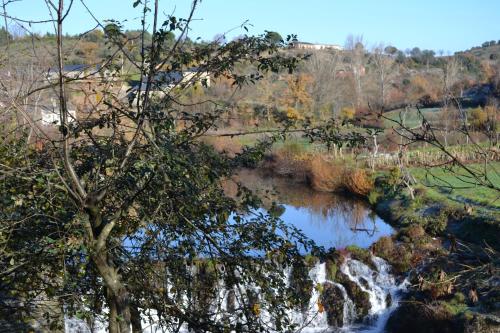 a river with a waterfall in a field at Casa de Onor in Rio de Onor