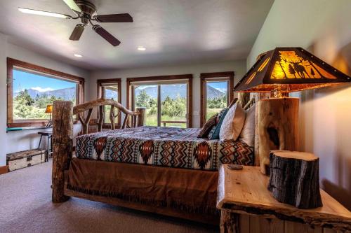 a bedroom with a bed and a table with a lamp at Mountain Sanctuary in Livingston