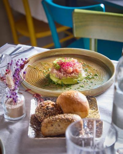 a plate of food on a table with bread at Apollo Boutique Hotel in Rome