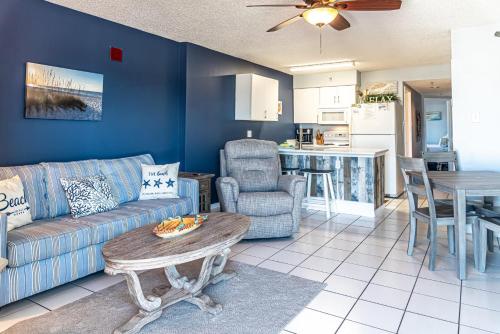 a living room with a couch and a table at Tradewinds 908 in Orange Beach
