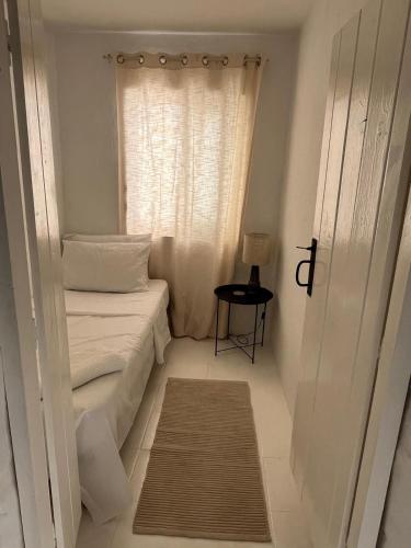 a small room with a bed and a window at townhouse cospicua , ( 3 cities-valletta ) ferry in Cospicua